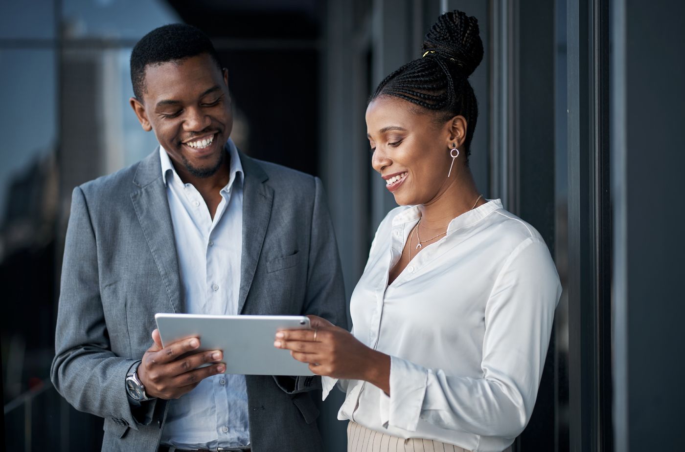 Two consultants reviewing a plan on a tablet